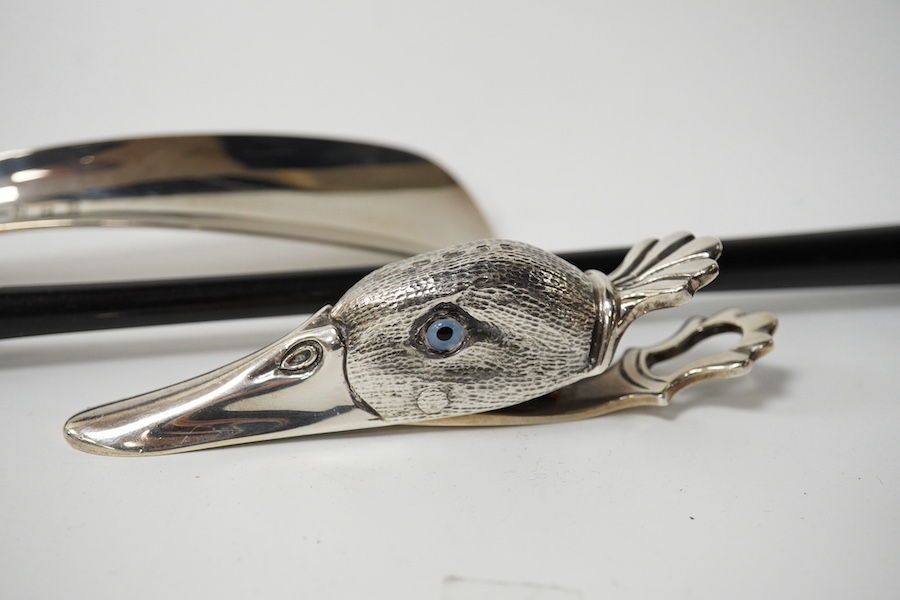 A modern novelty ebony handled silver back scratcher, 	Francis Howard Ltd, London, 2008, 38.6cm, a modern silver novelty duck’s head combination paperclip/match strike, London, 1905 and a silver shoe-horn. Condition - fa